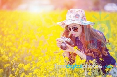 Woman Taking Photos At A Rapeseed Flowers Stock Photo