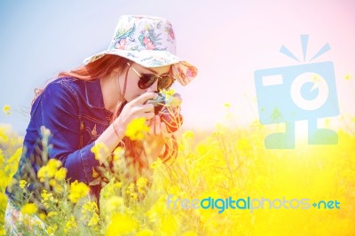 Woman Taking Photos At A Rapeseed Flowers Stock Photo