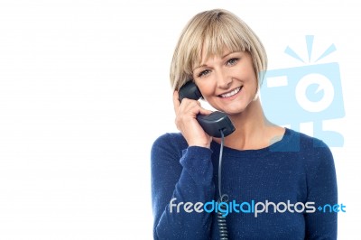 Woman Talking On The Landline Phone Stock Photo