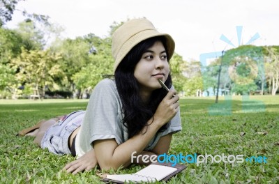 Woman Thinking Hard Studying Outside Stock Photo