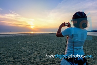 Woman Tourist Taking Photo On The Beach Stock Photo