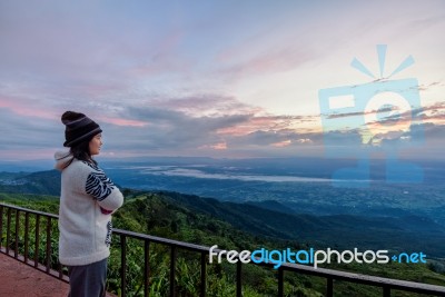 Woman Tourist Watching The Sunrise Stock Photo