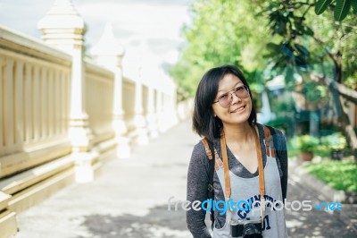 Woman Tourist With Camera Smile In The Thai Temple Stock Photo