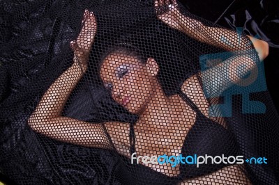 Woman Traped In Black Fishnet Stock Photo