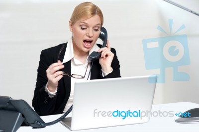 Woman Trying To Convince Client Over The Phone Stock Photo