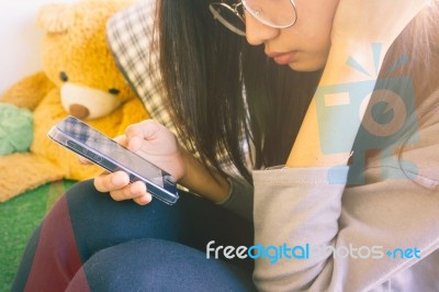 Woman Typing Text Message On Smart Phone In A Cafe Stock Photo