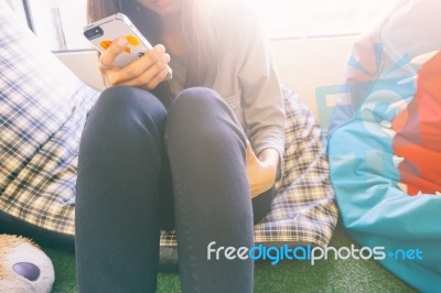 Woman Typing Text Message On Smart Phone In A Cafe Stock Photo