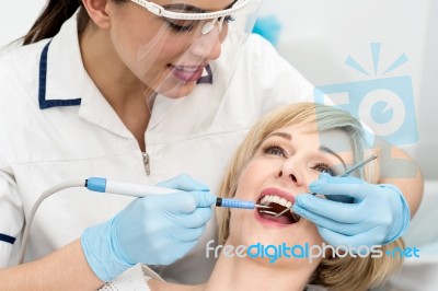 Woman Under A Dental Treatment Stock Photo