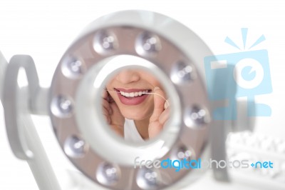 Woman Using Dental Floss Stock Photo