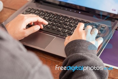 Woman Using Laptop At Office Desk Stock Photo