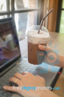 Woman Using Laptop In The Coffee Shop Stock Photo