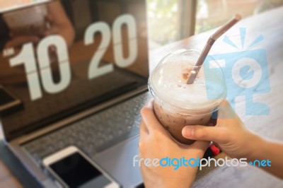 Woman Using Laptop In The Coffee Shop Stock Photo