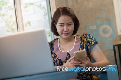 Woman Using Mobile Phone At Home Stock Photo