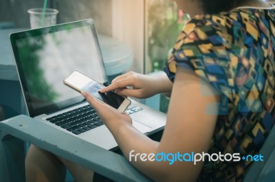 Woman Using Mobile Phone At Home Stock Photo