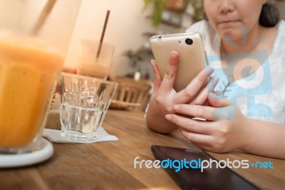 Woman Using Phone In Cafe Stock Photo