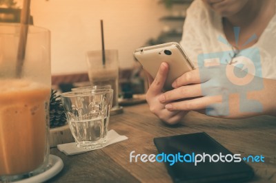 Woman Using Phone In Cafe Stock Photo