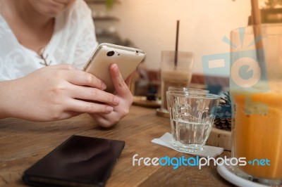 Woman Using Phone In Cafe Stock Photo