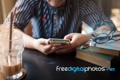 Woman Using Phone In Cafe Stock Photo