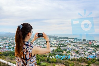 Woman Using Phone Taking Pictures Stock Photo