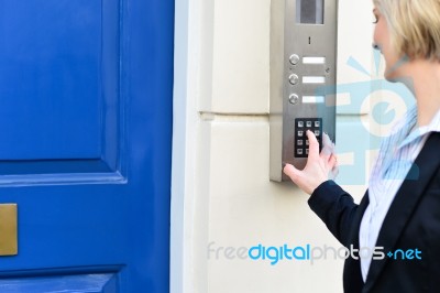 Woman Using Security System Stock Photo