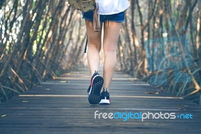 Woman Walking On Wooden Bridge. Vintage Tone Stock Photo