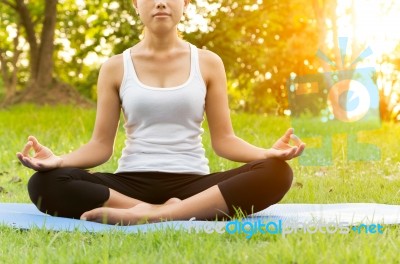 Woman Was Meditation Yoga In Park At Eveing Stock Photo