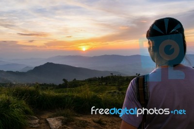 Woman Watching Sunset Stock Photo