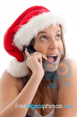 Woman Wearing Christmas Hat And Talking On Cell Phone Stock Photo