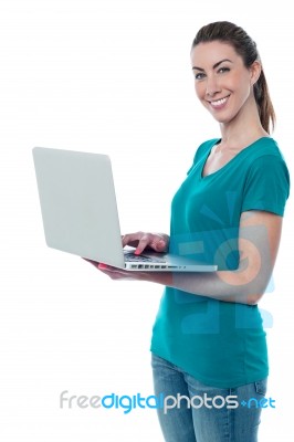 Woman With A Bright Smile, Using Laptop Stock Photo