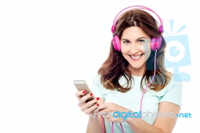 Woman With Cell Phone And Hear Phone Stock Photo