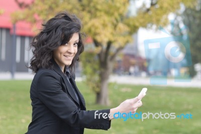 Woman With Cell Phone Walking Stock Photo