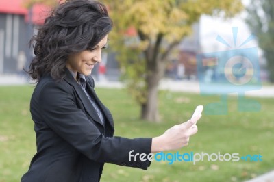 Woman With Cell Phone Walking Stock Photo