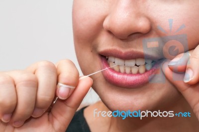 Woman With Dental Floss Stock Photo