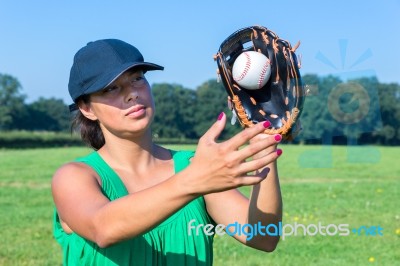 Woman With Glove And Cap Catching Baseball Stock Photo