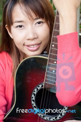 Woman With Guitar Stock Photo