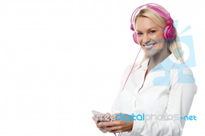 Woman With Headphones And Cell Phone Stock Photo