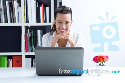 Woman With Laptop Working At Home Stock Photo