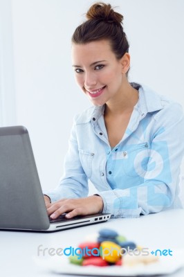 Woman With Laptop Working At Home Stock Photo