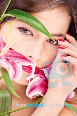 Woman With Oriental Flowers Stock Photo