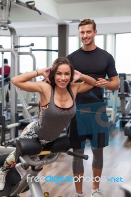 Woman With Personal Trainer  In Gym Stock Photo