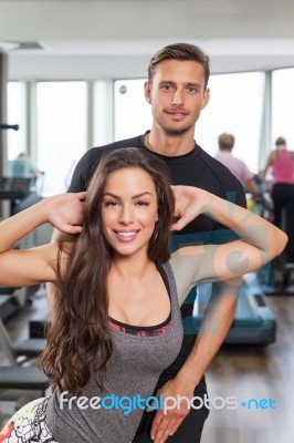 Woman With Personal Trainer  In Gym Stock Photo