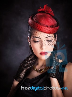 Woman With Red Hat And Black Gloves Stock Photo