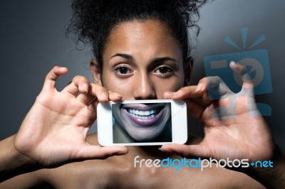 Woman With Smartphone. Concept Of Hypocrisy Stock Photo