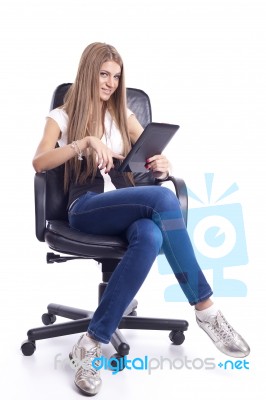 Woman With Tablet Computer In Office Chair Stock Photo