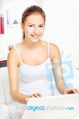 Woman Working On Laptop At Home Stock Photo