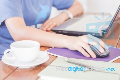 Woman Working With Laptop In Coffee Shop Stock Photo