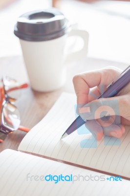 Woman Writing A Plan On Notebook Stock Photo