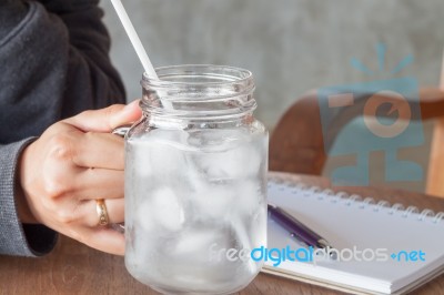 Woman's Hand Holding A Cold Glass Of Water Stock Photo