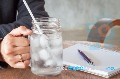 Woman's Hand Holding A Cold Glass Of Water Stock Photo