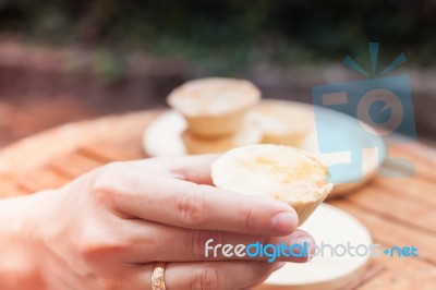 Woman's Hand Holding Mini Pies Stock Photo